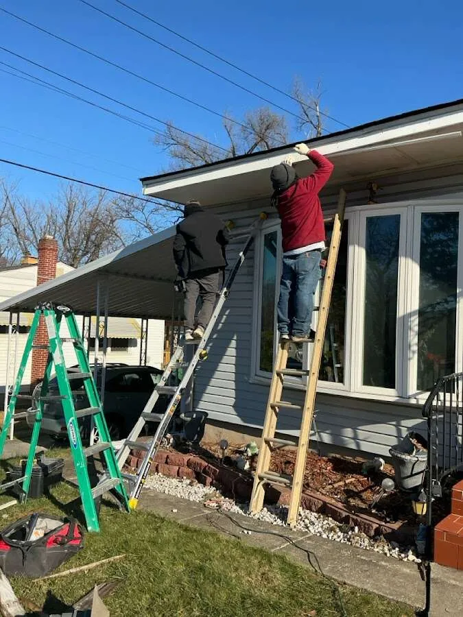 Restoration crew performing exterior repair in Fairport